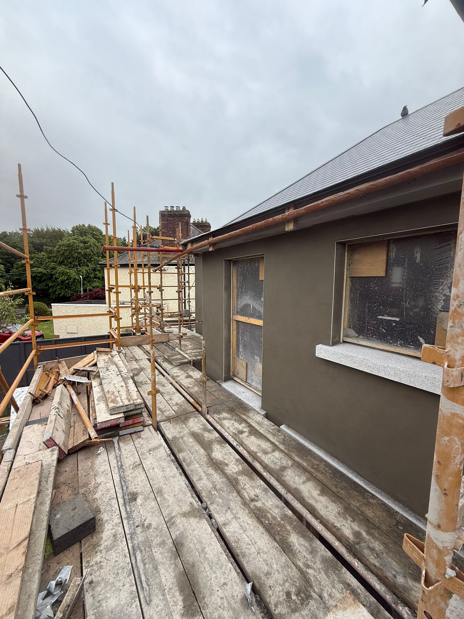 House renovation external rendering with scaffolding — Causani Plastering Dublin