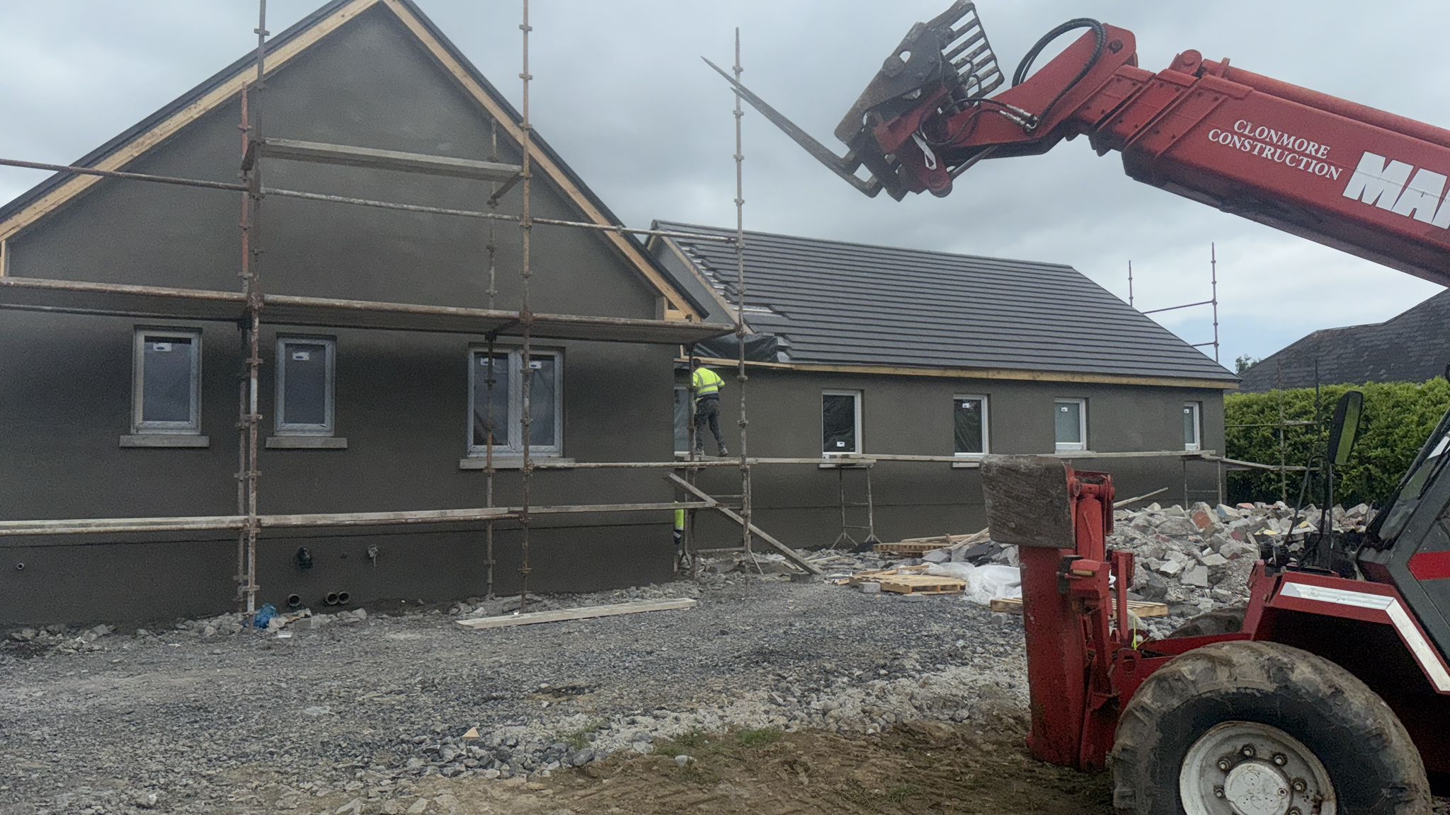 Causani Plastering team applying external render to a full house facade across Ireland